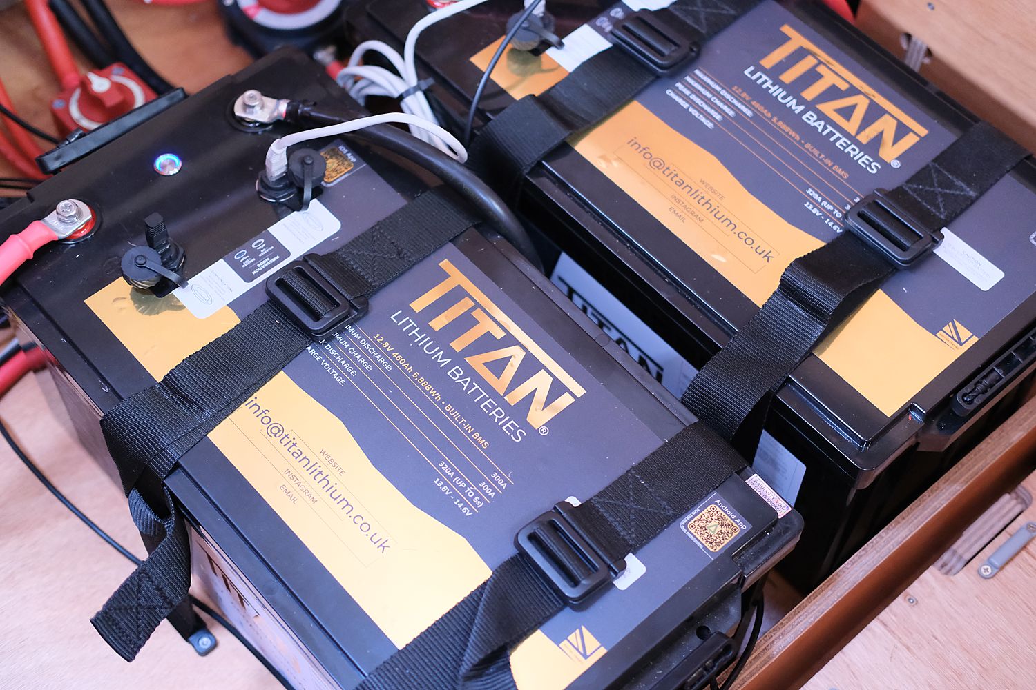Top-down view of two TITAN 460Ah batteries and Victron wiring aboard Runa